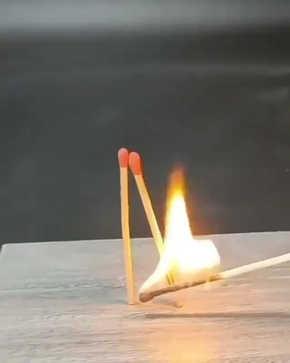 a pair of matchsticks hitting a match on a table