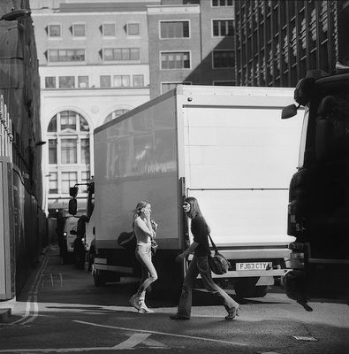 a couple of people walking across a street