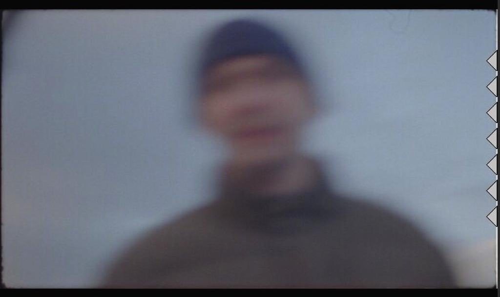 a blurry photo of a man with a hat on