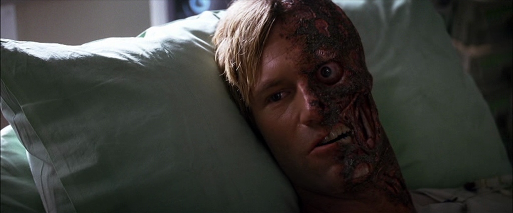 a man laying in bed with a bloody face on his face