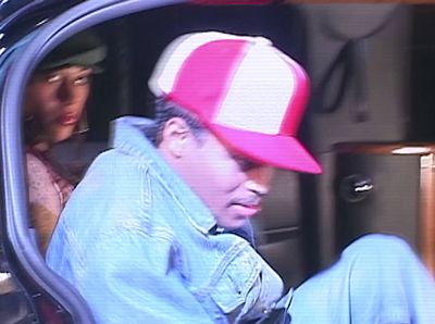 a man in a red and white hat sitting in a car