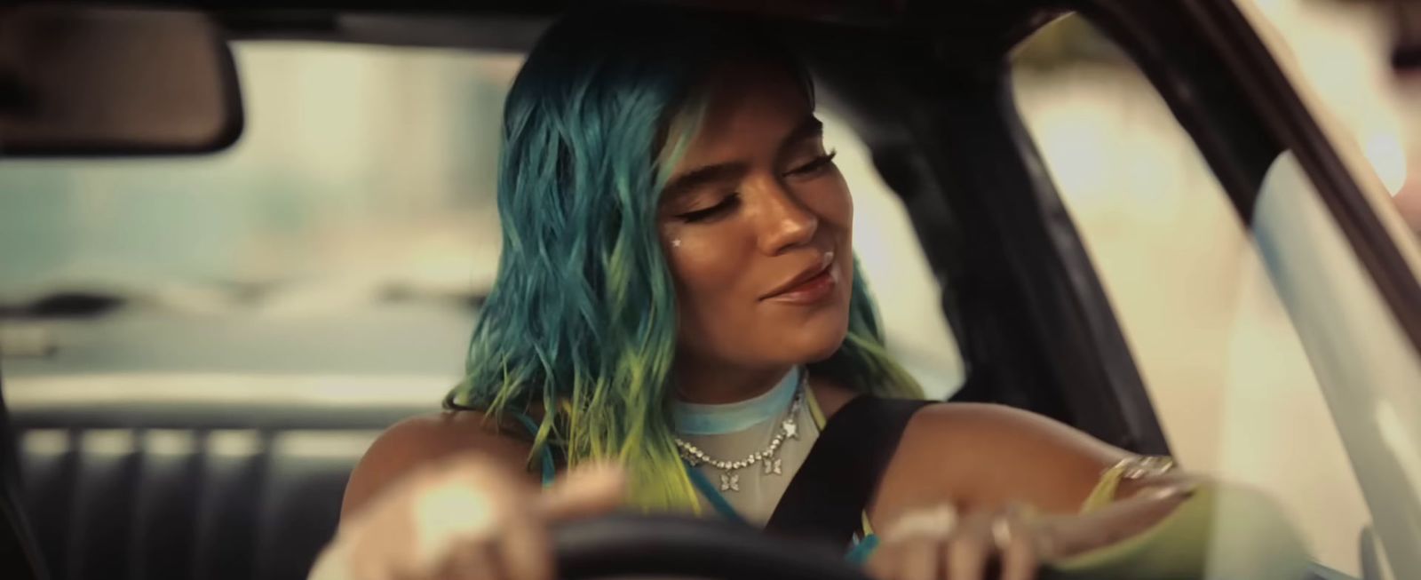 a woman with green hair sitting in a car