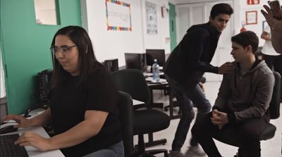 a group of people in a room with computers