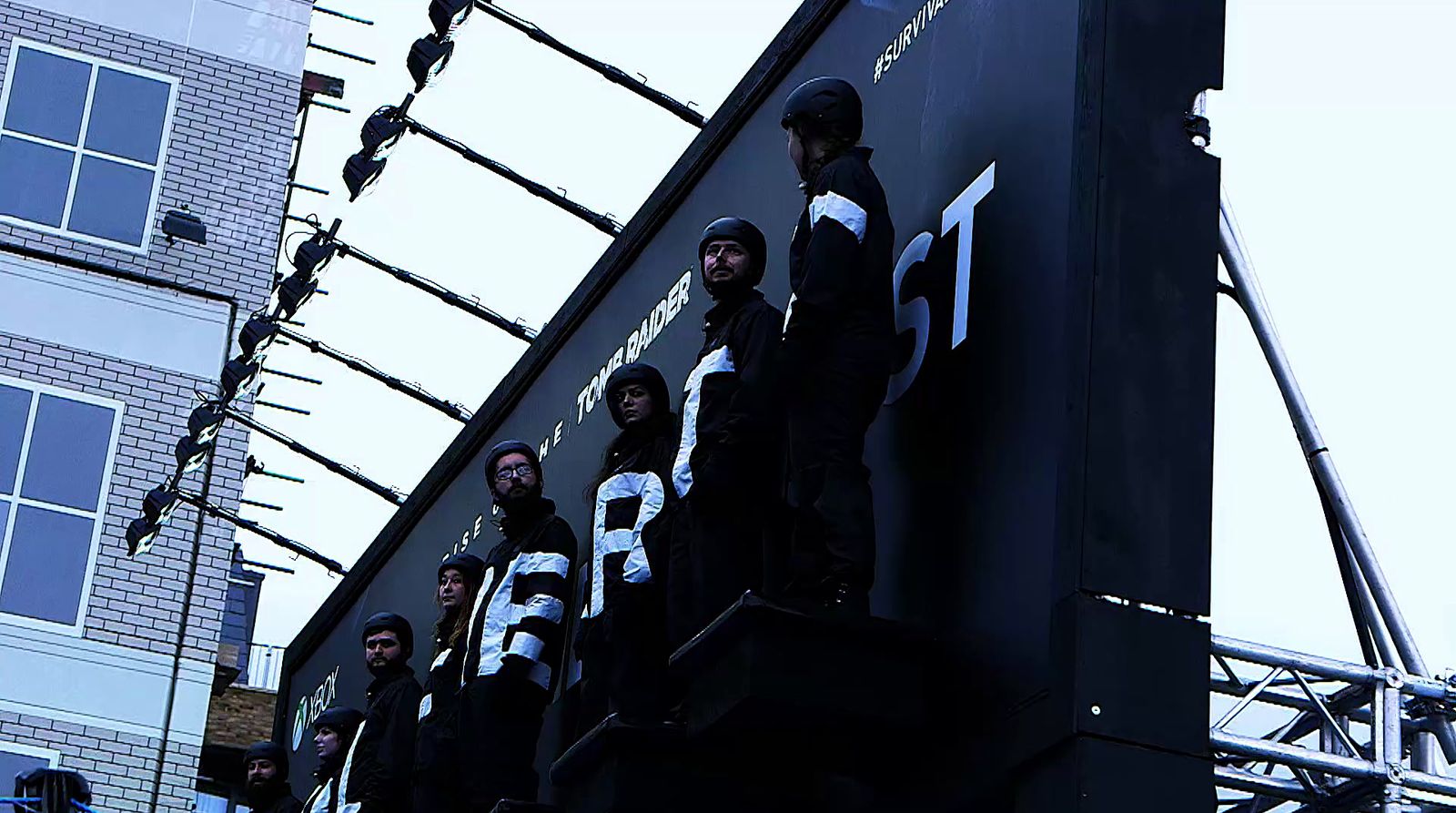 a group of people standing on top of a building