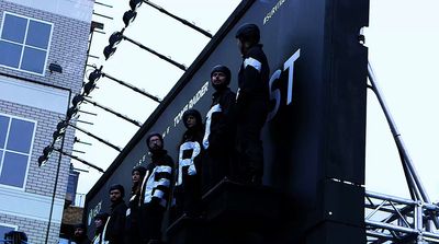 a group of people standing on top of a building