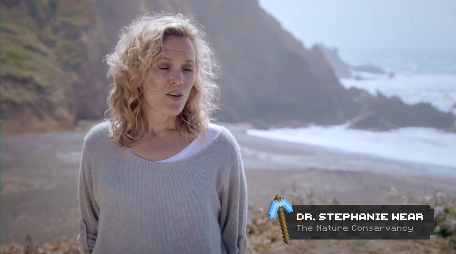 a woman standing on a beach next to the ocean