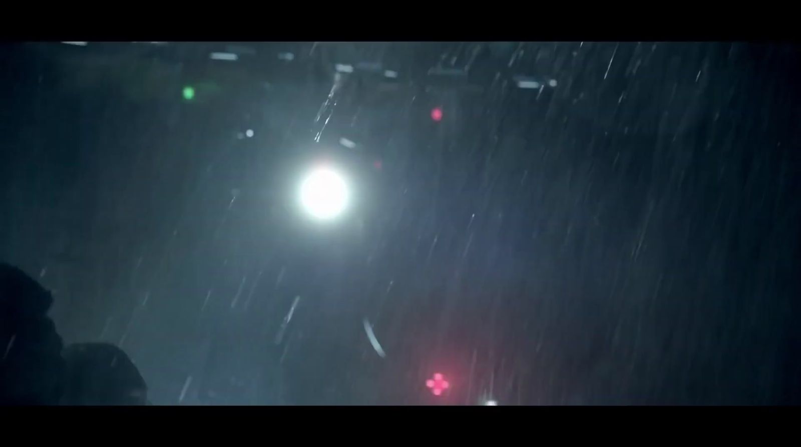 a person standing under a street light in the rain