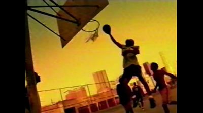 a person jumping up into the air with a basketball