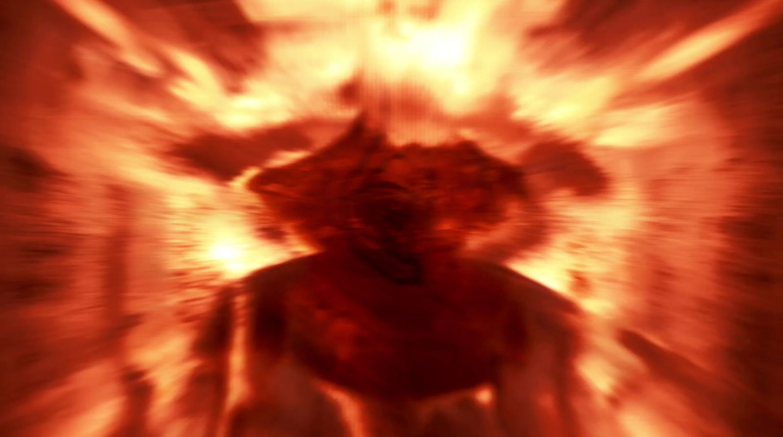 a blurry image of a person standing in front of a fire