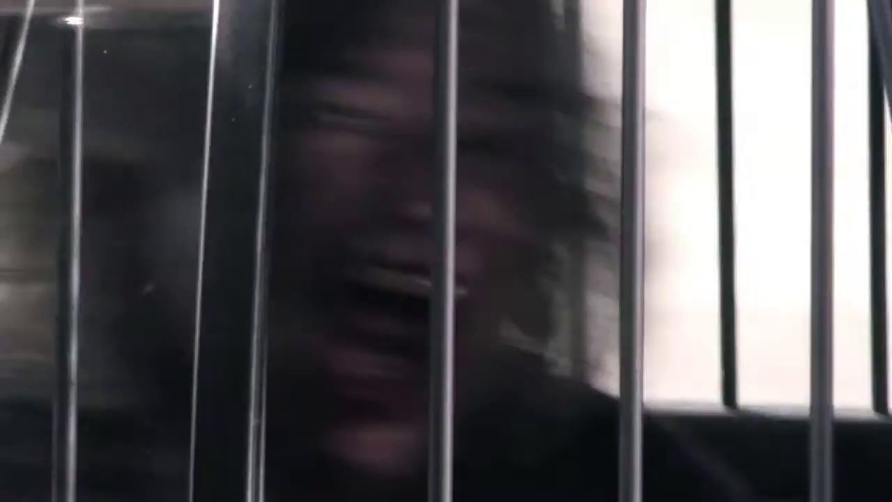 a blurry photo of a person behind bars