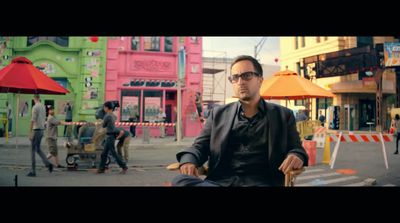 a man sitting in a chair on a city street