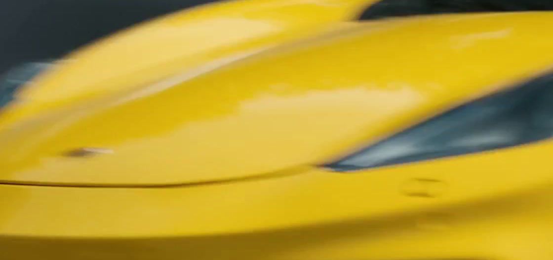 a close up of a yellow sports car