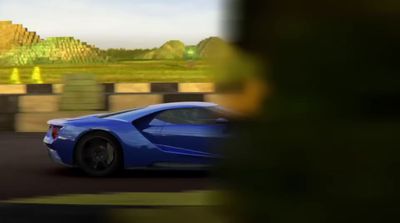 a blue sports car driving down a street