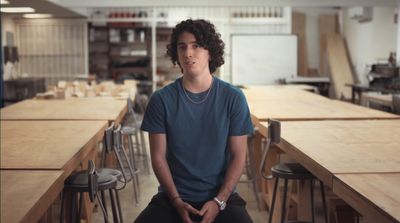 a young man sitting at a table in a restaurant