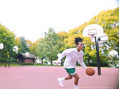 a young man is playing basketball on a court