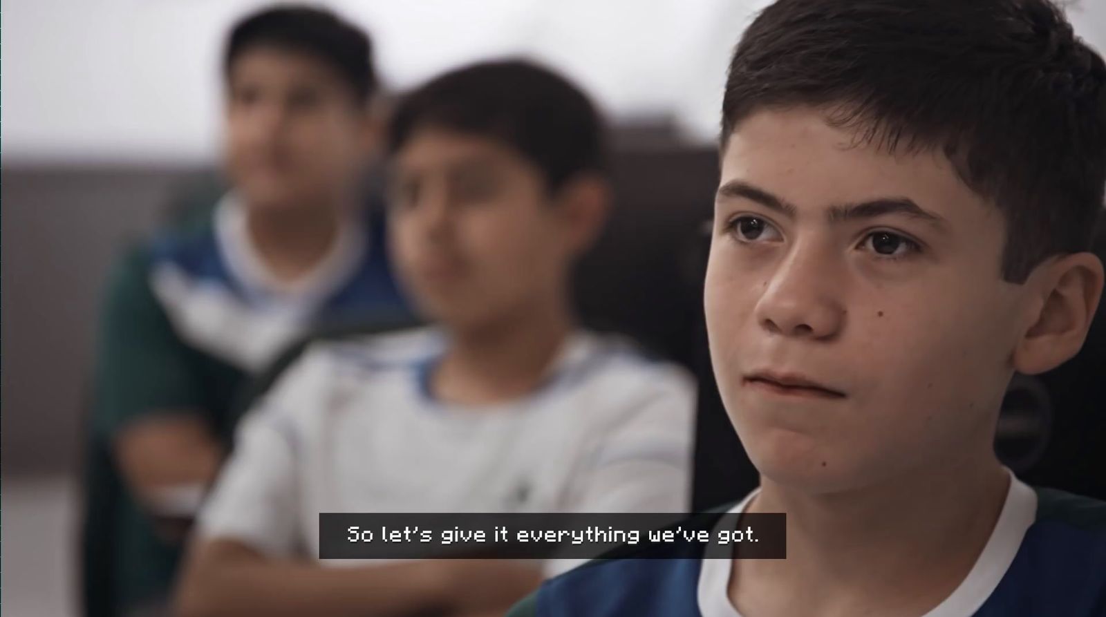 a group of young boys sitting next to each other