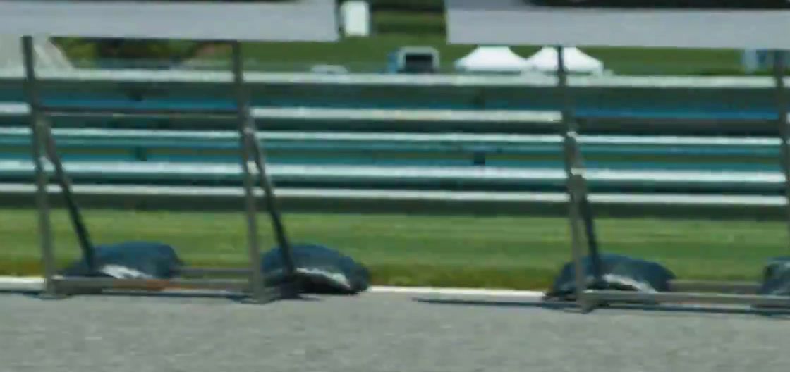 a row of empty seats sitting on the side of a race track