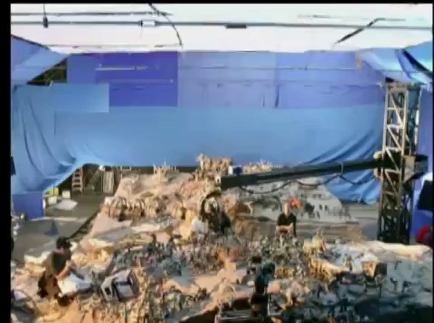 a group of people standing around a pile of rubble