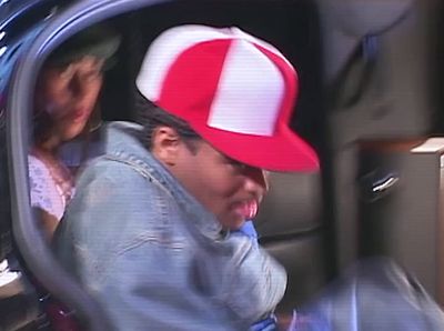 a man in a red and white hat sitting in a car