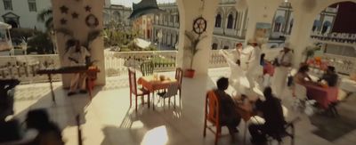 a group of people sitting at a table in a restaurant