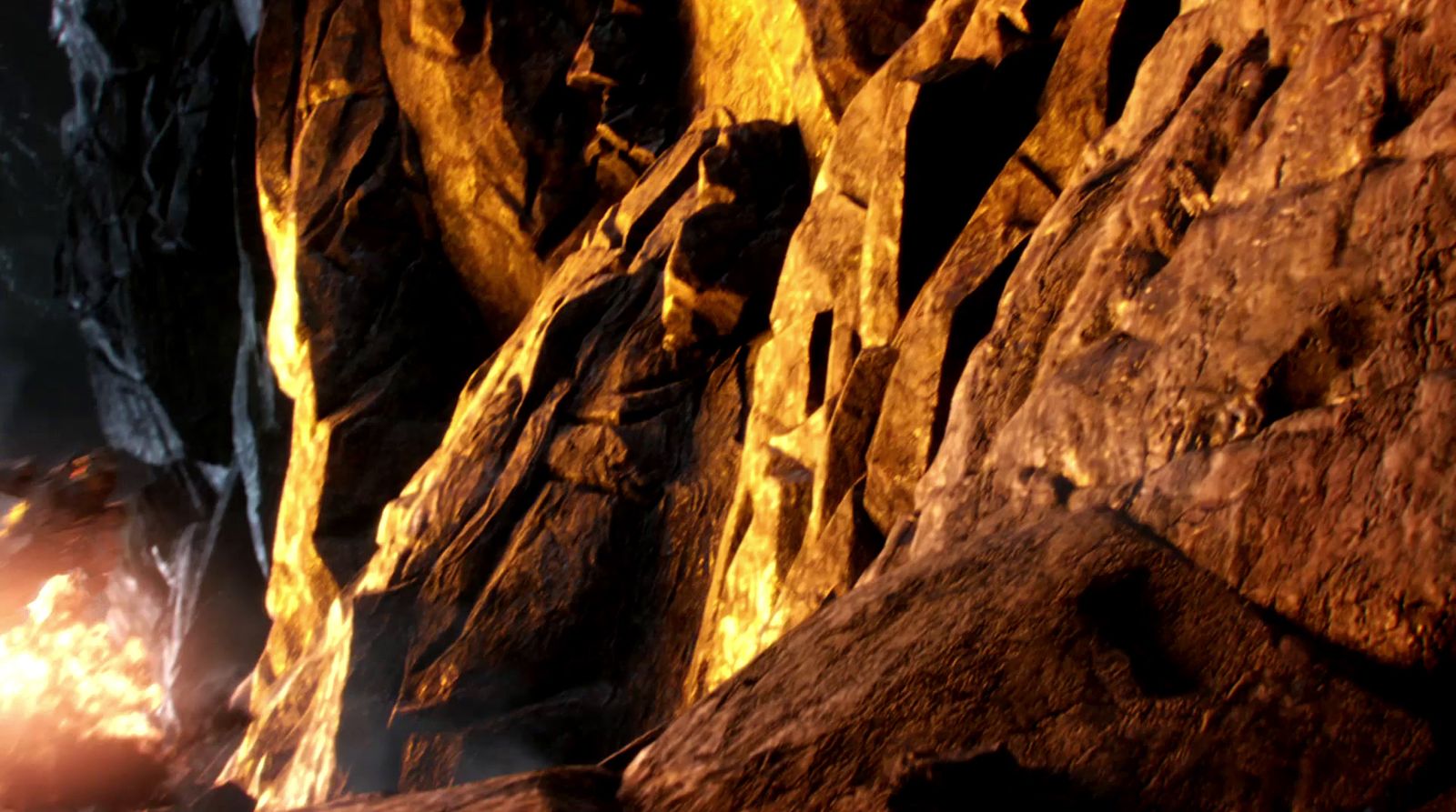 a man standing next to a fire in a cave