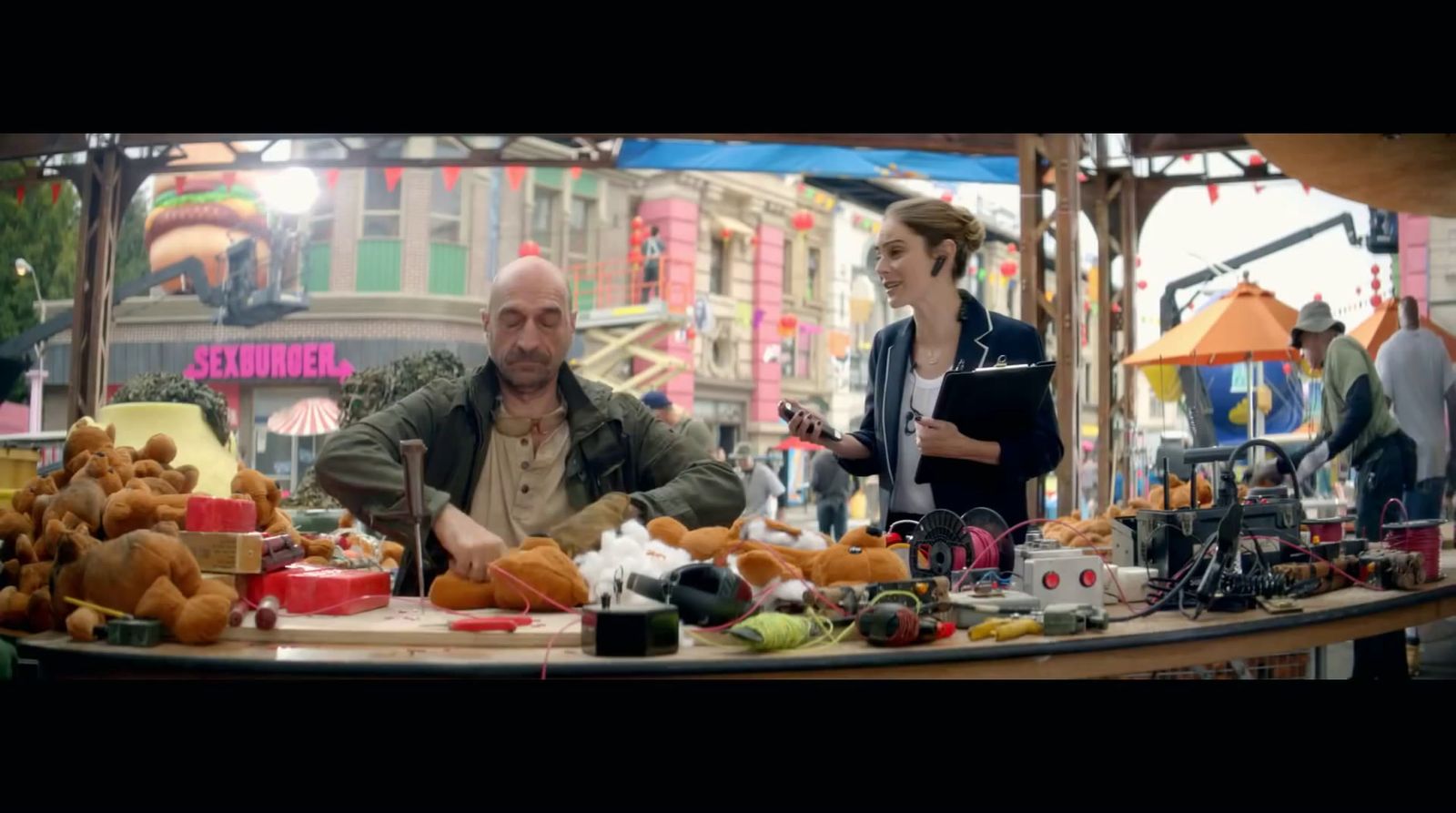 a man sitting at a table in front of a woman