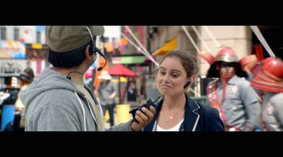 a woman talking to a man in a crowd of people