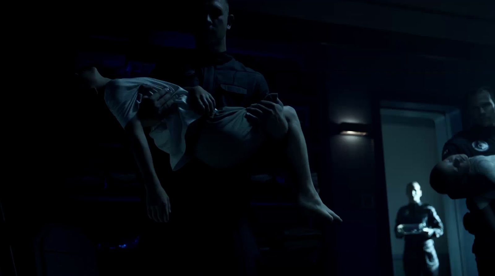 a man standing next to a woman in a dark room