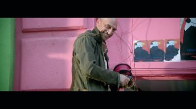 a man standing in front of a pink wall