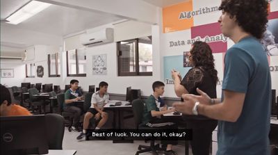 a man standing in front of a classroom full of students