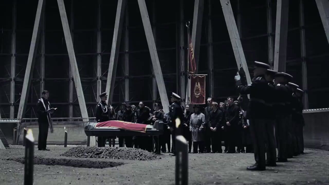 a group of people standing around a casket