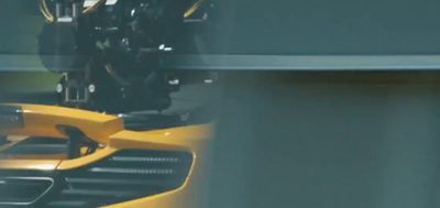 a close up of a yellow sports car