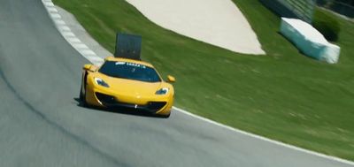 a yellow sports car driving down a race track