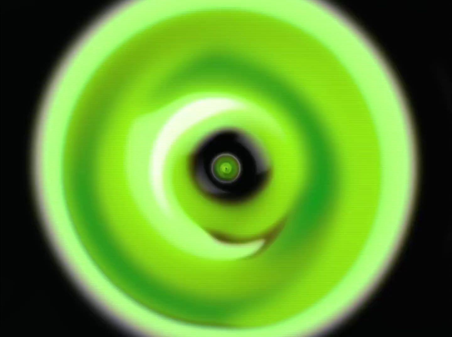 a green circular object with a black background