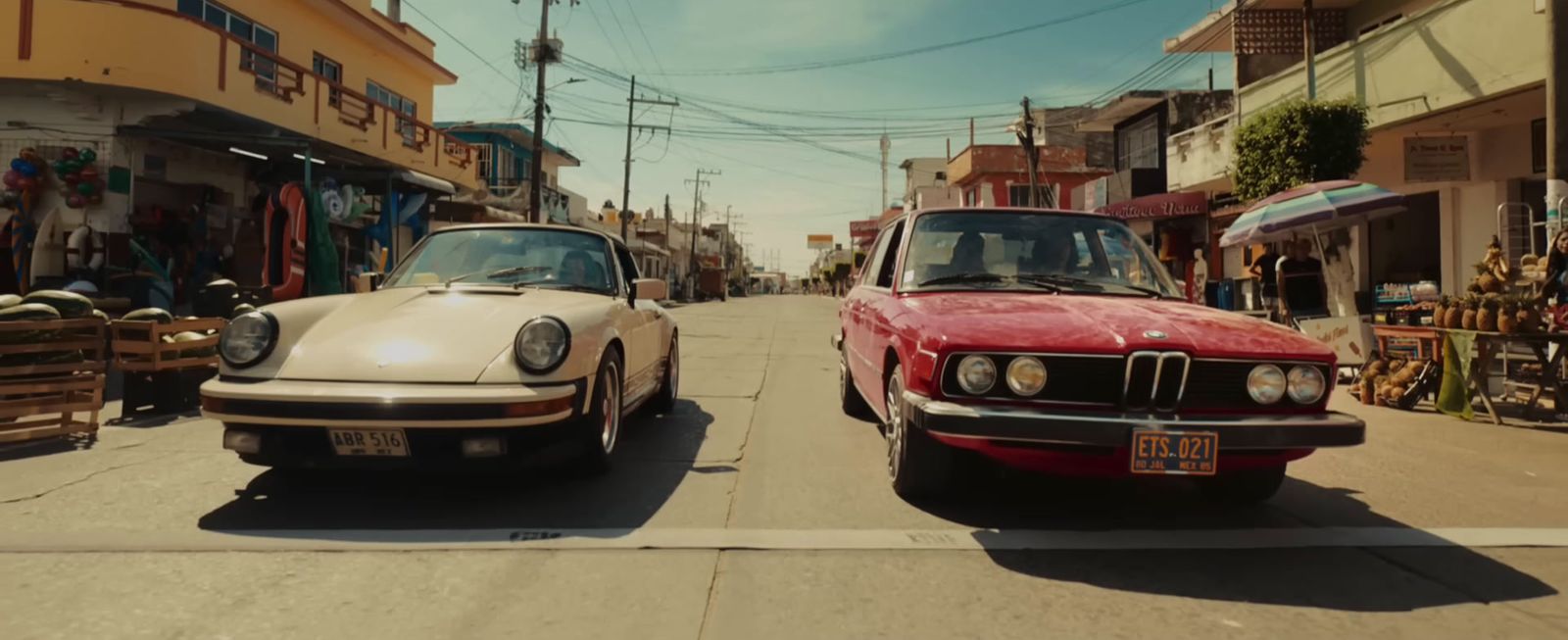 a couple of cars parked next to each other on a street