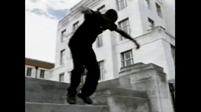 a man riding a skateboard down the side of a cement wall