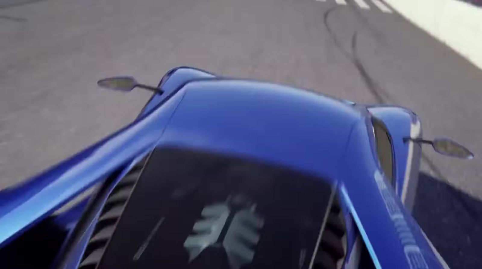 a blue sports car driving down a street