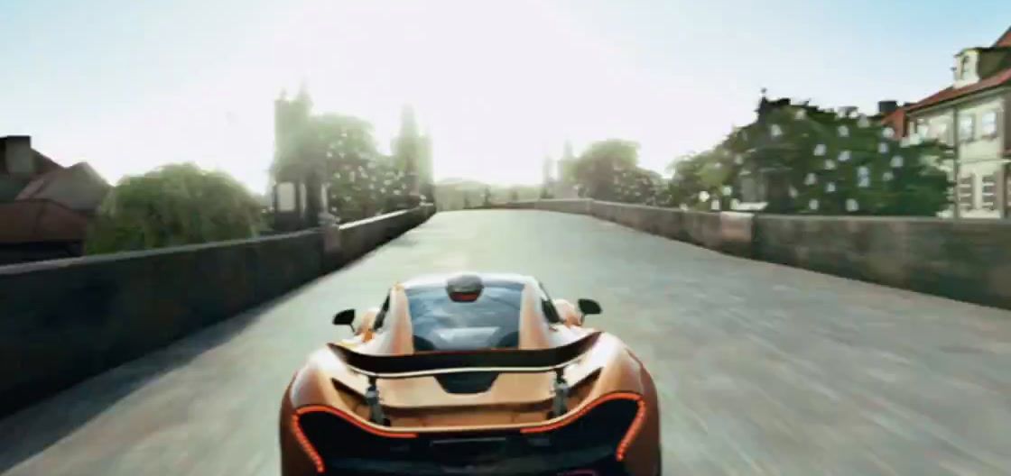 an orange sports car driving down a road