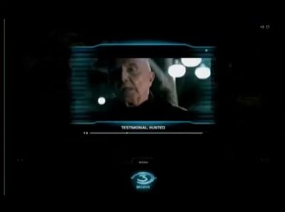 an old man on a television screen in the dark