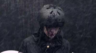 a person wearing a helmet in the rain