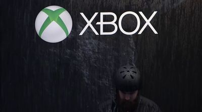 a man standing in front of a xbox logo