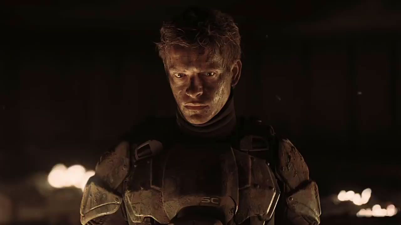 a man in a futuristic suit standing in a dark room