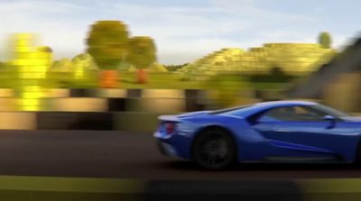 a blue sports car driving down a street