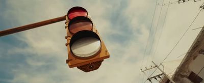 a red traffic light hanging from a metal pole