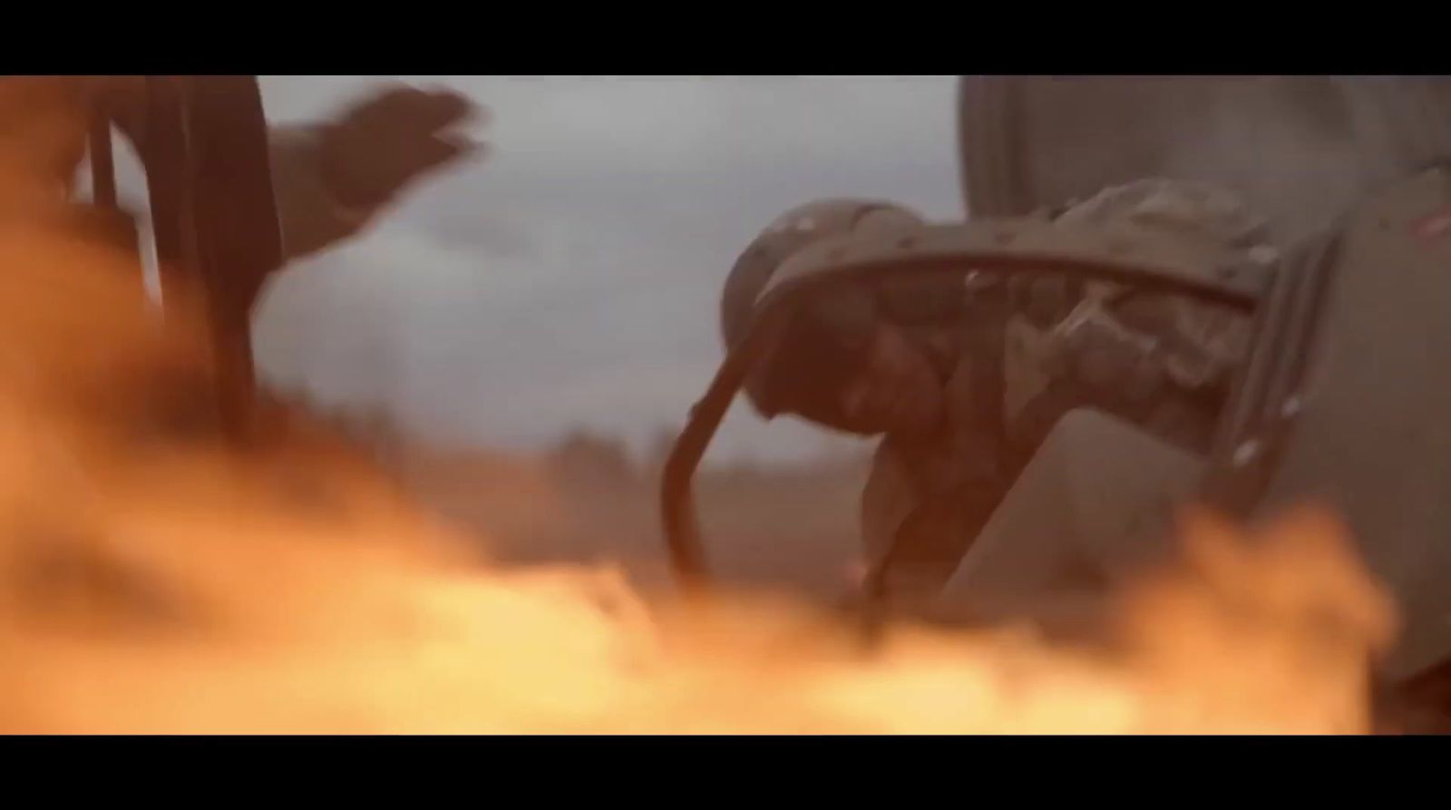 a close up of a fire with a person in the background