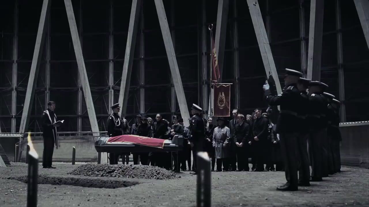 a group of people standing around a casket