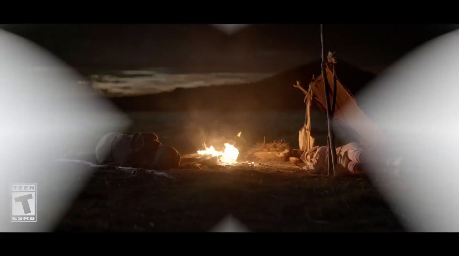 a campfire in the middle of a field at night