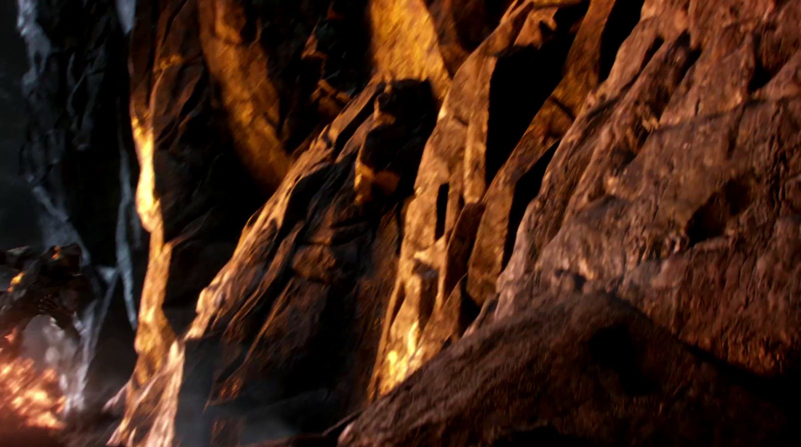 a man standing in a cave next to a fire