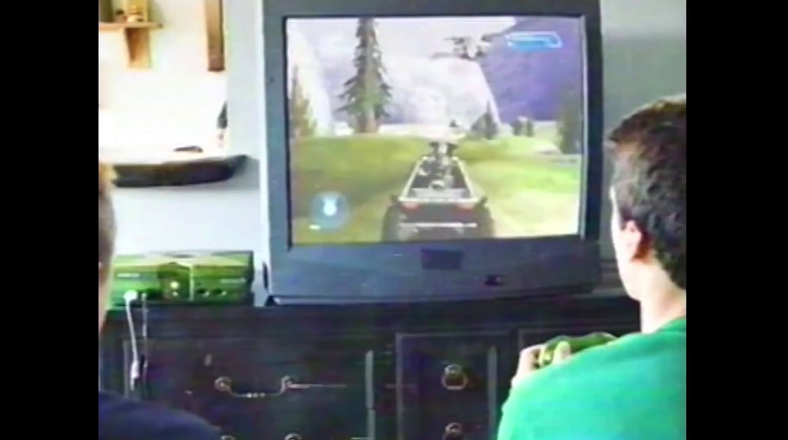 a man is playing a video game on a television