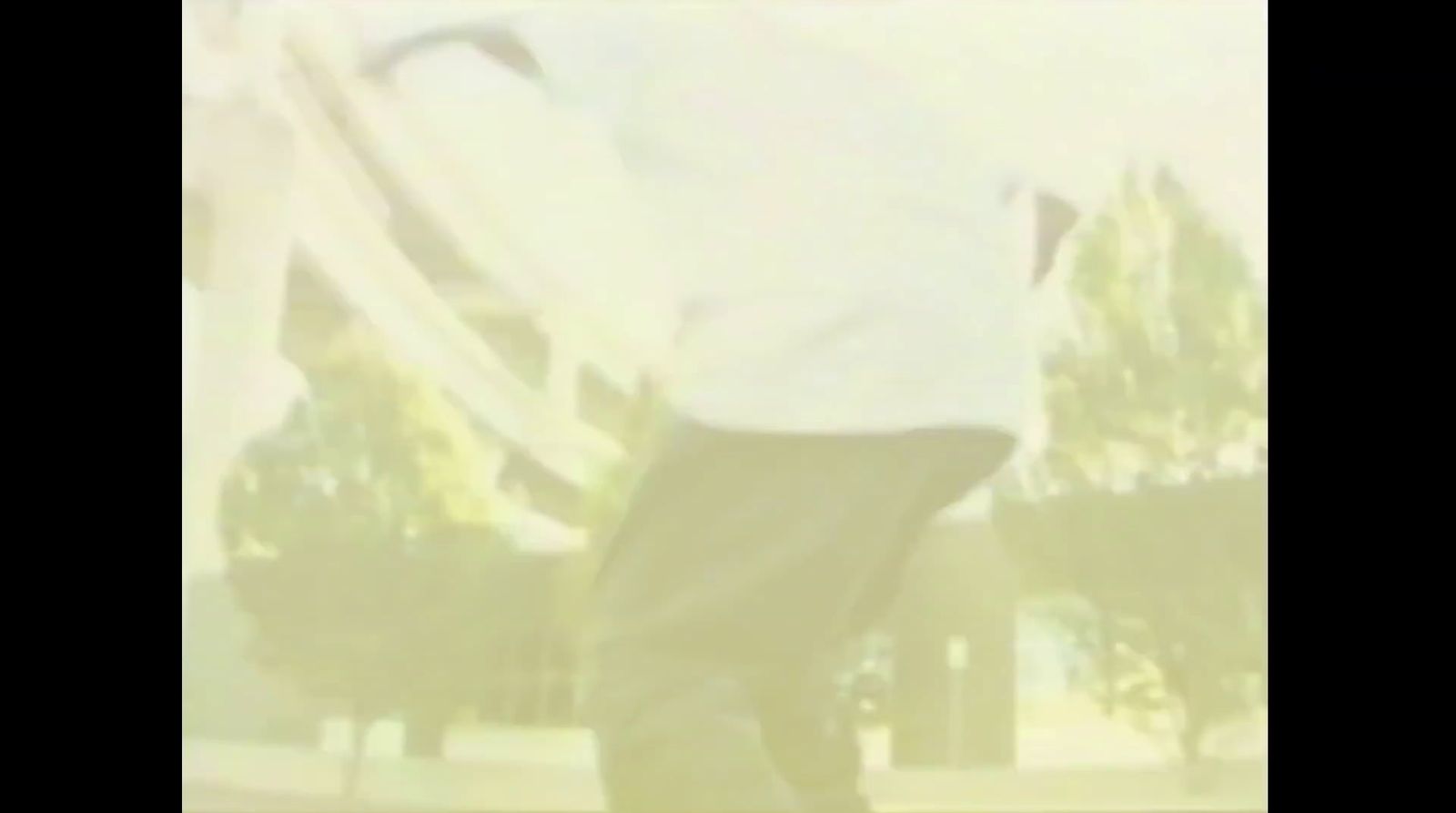 a man riding a skateboard on top of a sidewalk